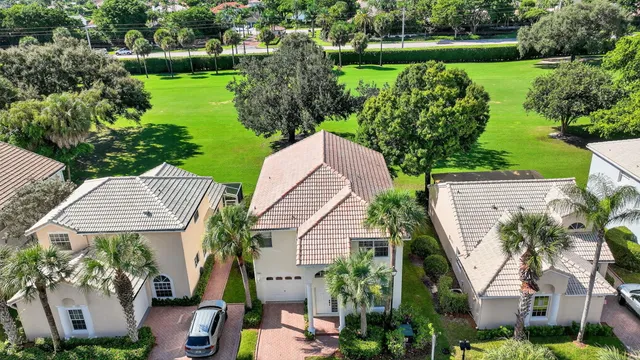 an aerial view of a residential houses with outdoor space and street view