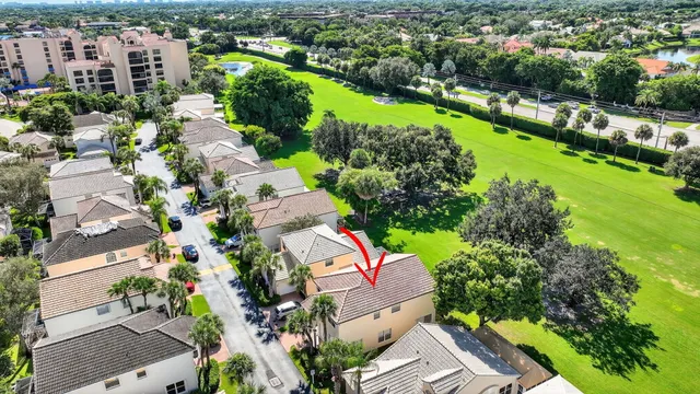 an aerial view of a houses with a lake view and a mountain