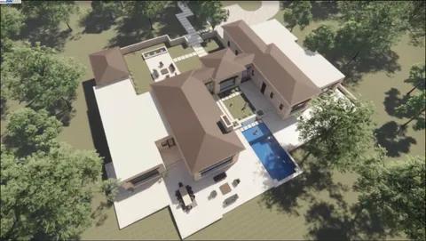 an aerial view of a house with outdoor space and parking