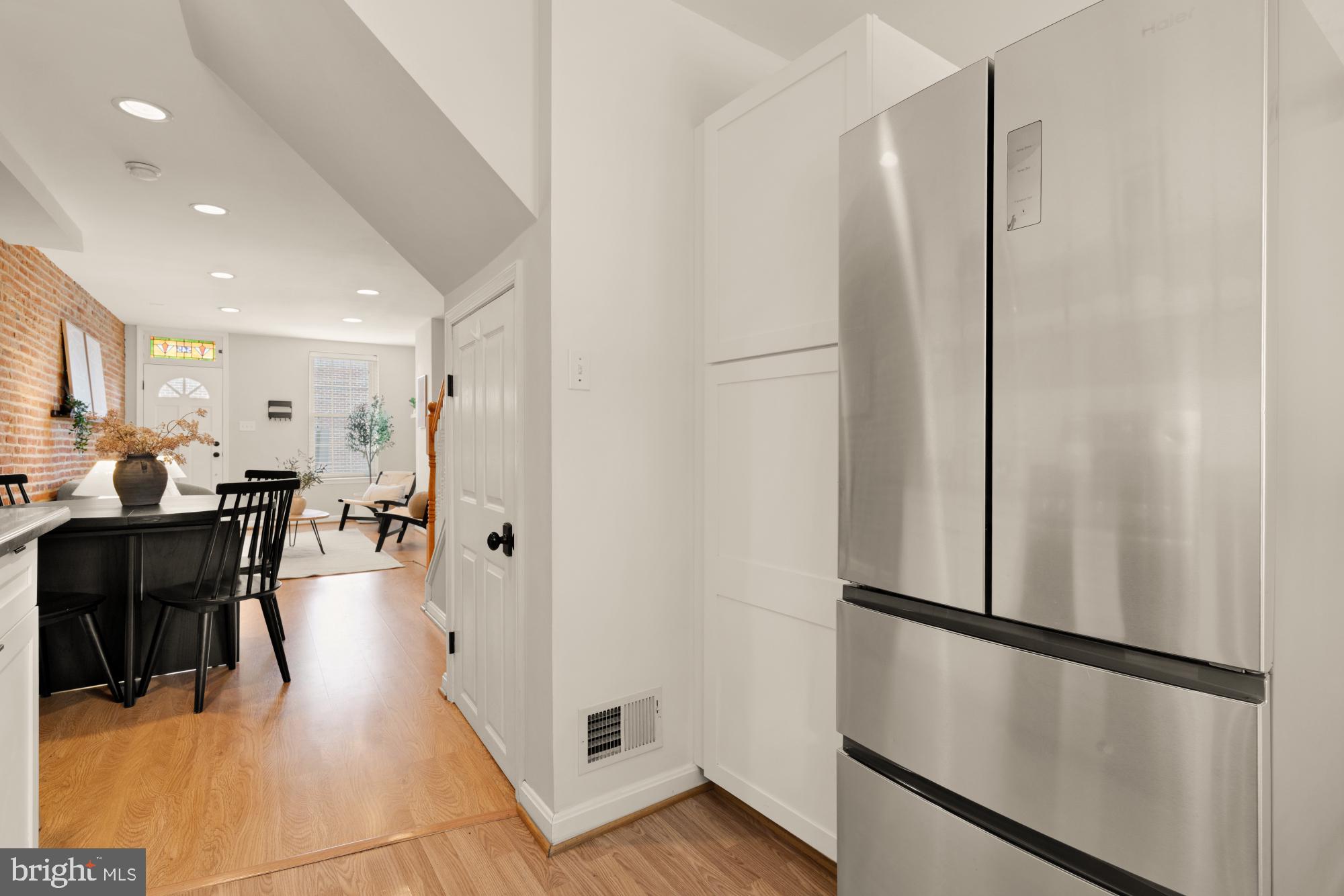 545 Gittings Street Baltimore, MD 21230 - Photo 11 of 40 a kitchen with stainless steel appliances refrigerator stove dining table and chairs