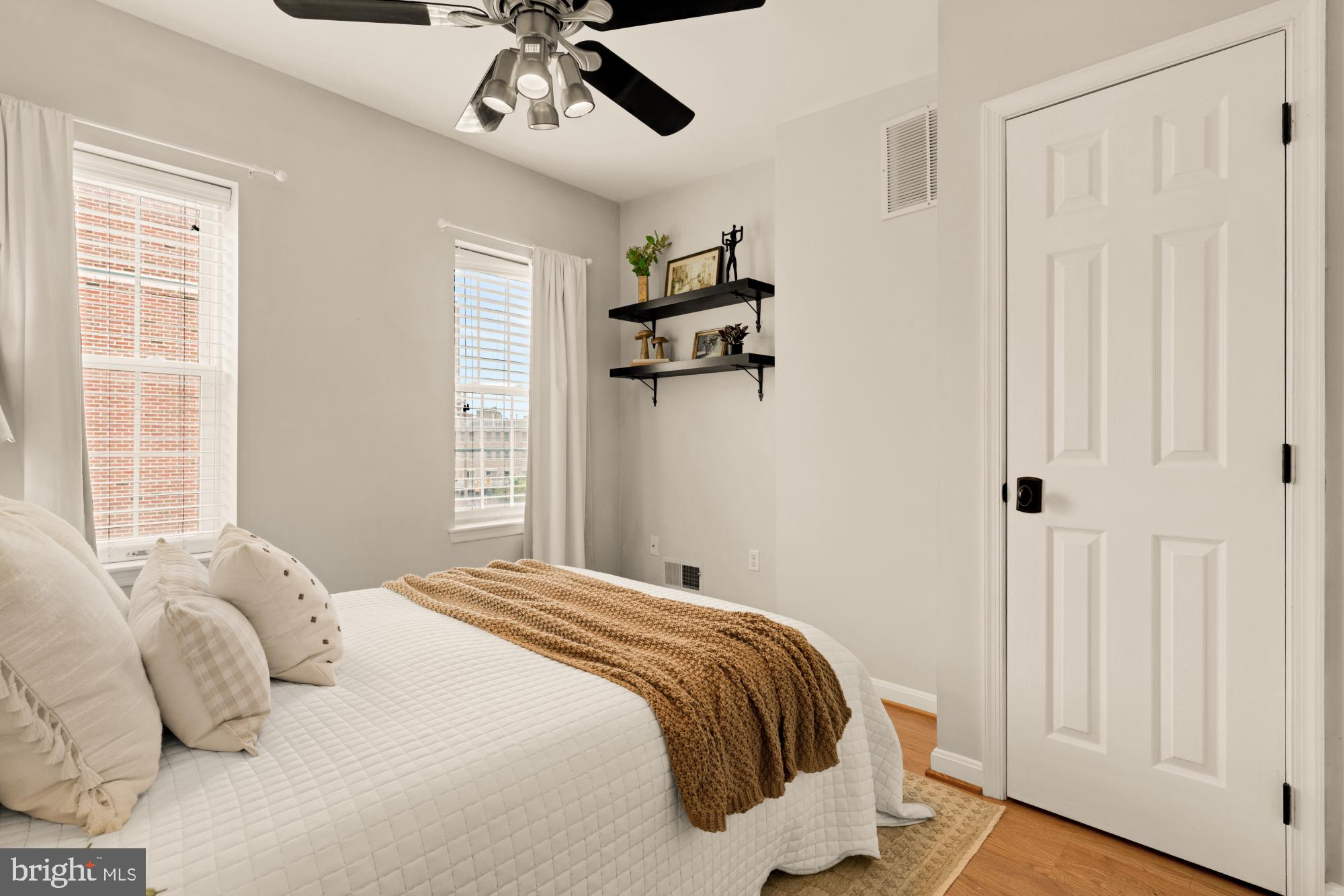 545 Gittings Street Baltimore, MD 21230 - Photo 14 of 40 a bedroom with a bed and wooden floor