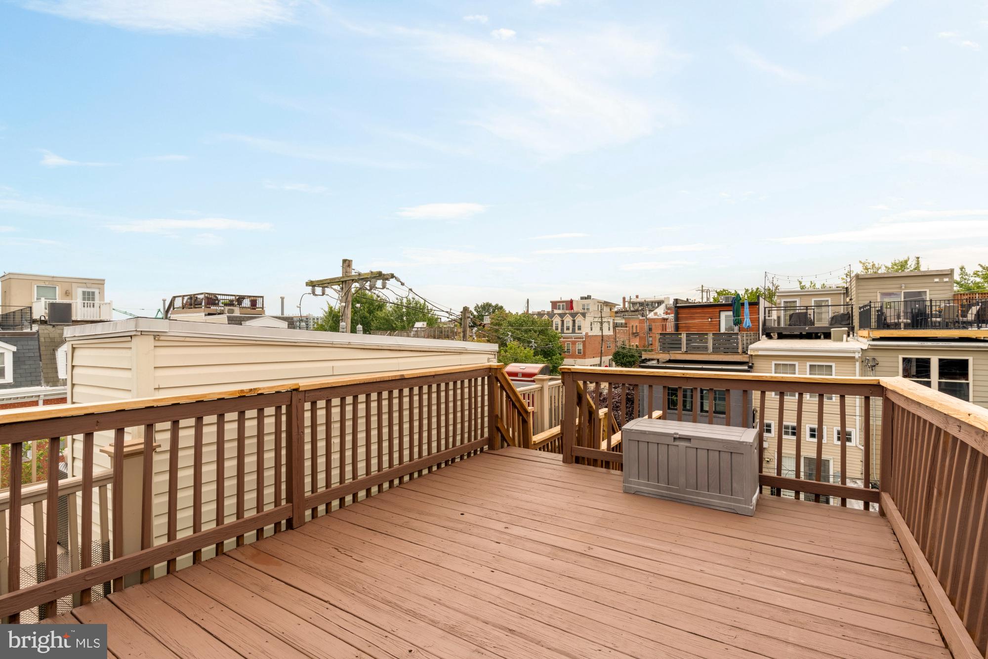545 Gittings Street Baltimore, MD 21230 - Photo 22 of 40 a view of a balcony with wooden floor and city view