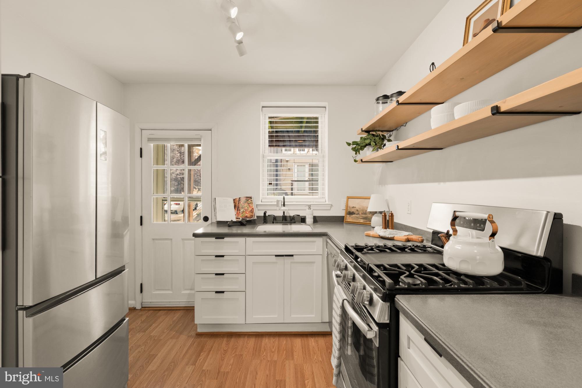 545 Gittings Street Baltimore, MD 21230 - Photo 8 of 40 a kitchen with stainless steel appliances granite countertop a stove and a refrigerator