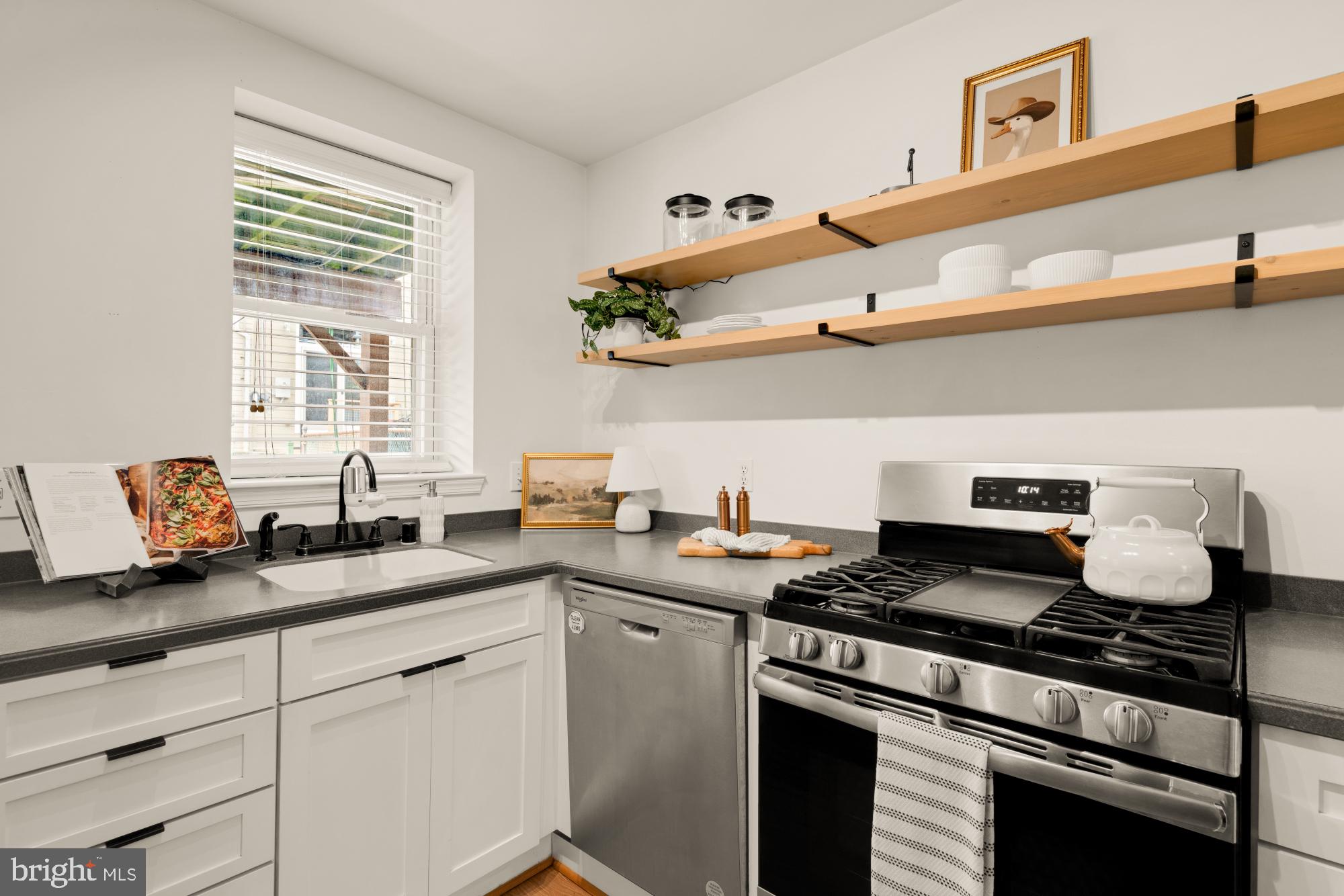 545 Gittings Street Baltimore, MD 21230 - Photo 10 of 40 a kitchen with stainless steel appliances granite countertop a sink and cabinets