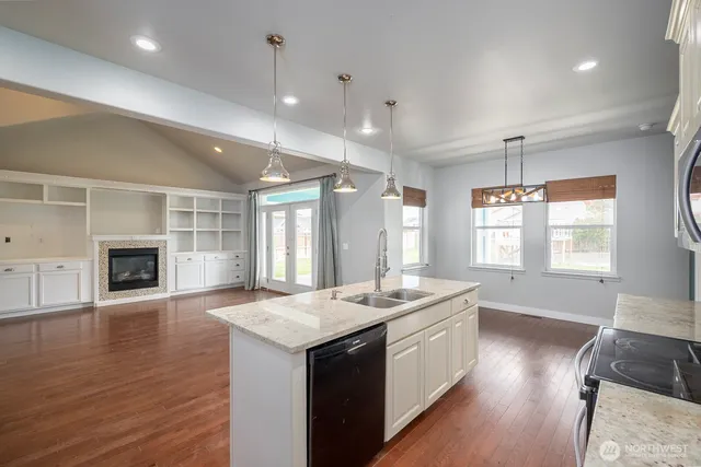 a large white kitchen with a large window