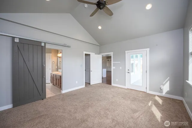 a view of a livingroom with a ceiling fan and window