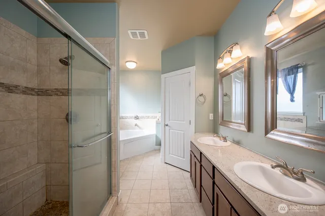 a bathroom with a granite countertop sink mirror and shower