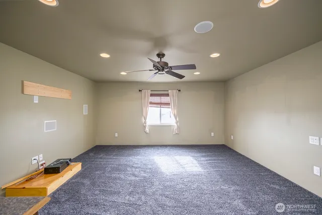 a view of room with a ceiling fan and window