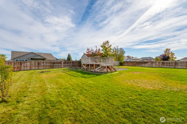 a view of swimming pool with outdoor seating and covered with trees in the background