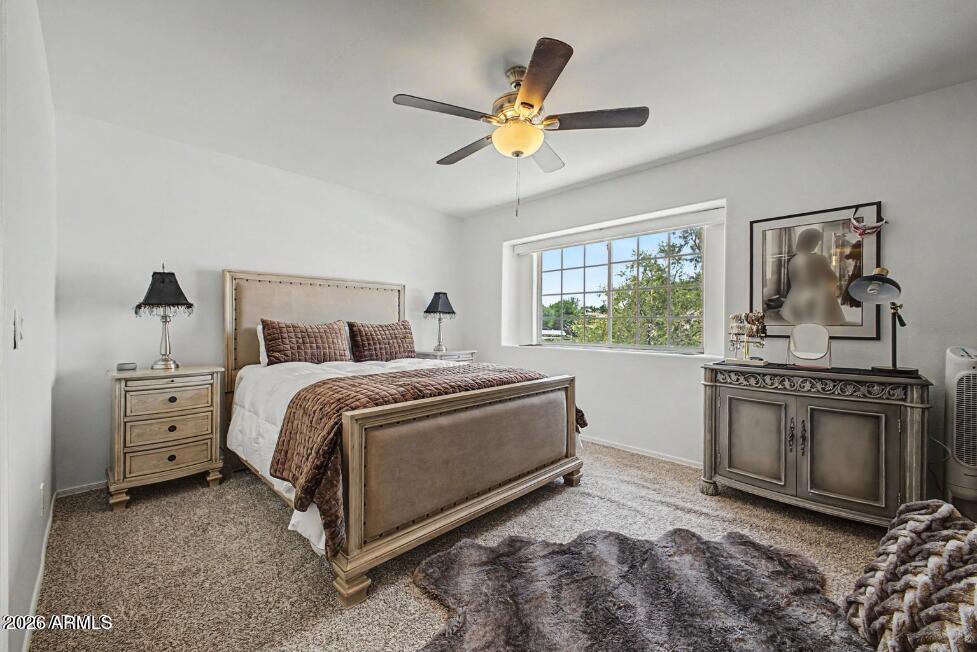 860 North McQueen Road, Unit 1135 Chandler, AZ 85225 - Photo 12 of 24 a bedroom with a bed and a chandelier