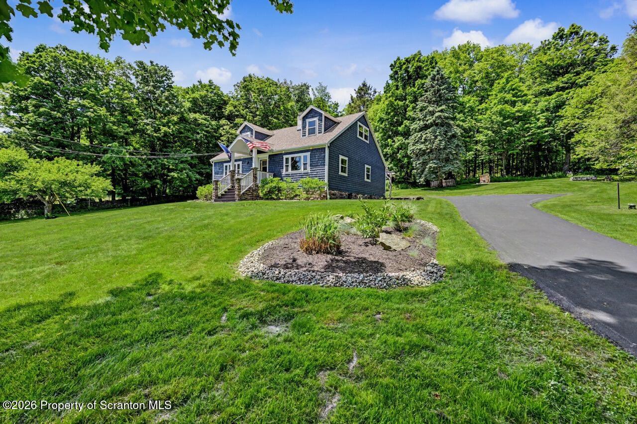 457 Craig Road Dalton, PA 18414 - Photo 9 of 114 a front view of a house with a yard and trees