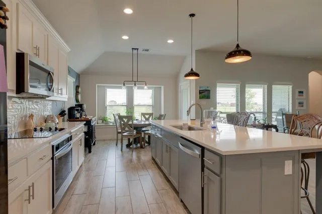 a kitchen with lots of counter space dining table and chairs