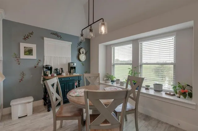 a view of a dining room with furniture window and outside view