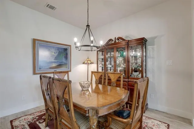 a kitchen with granite countertop kitchen island stainless steel appliances sink cabinets and wooden floor