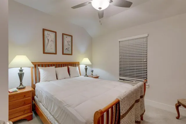 a dining room with wooden floor a chandelier a wooden table and chairs