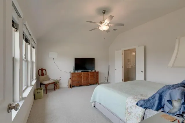 a bathroom with a toilet a sink a mirror a bathtub and shower