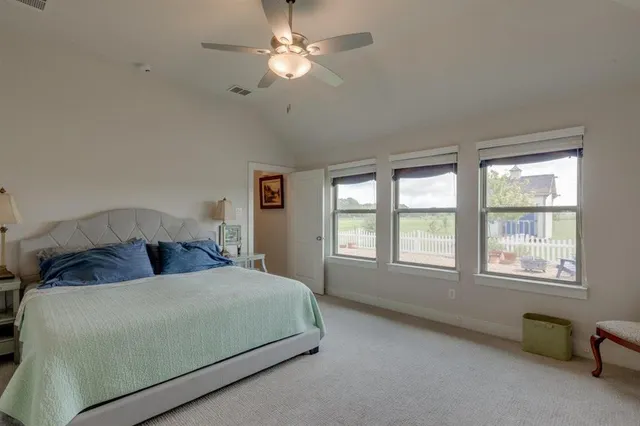 a bedroom with a large bed and a chandelier