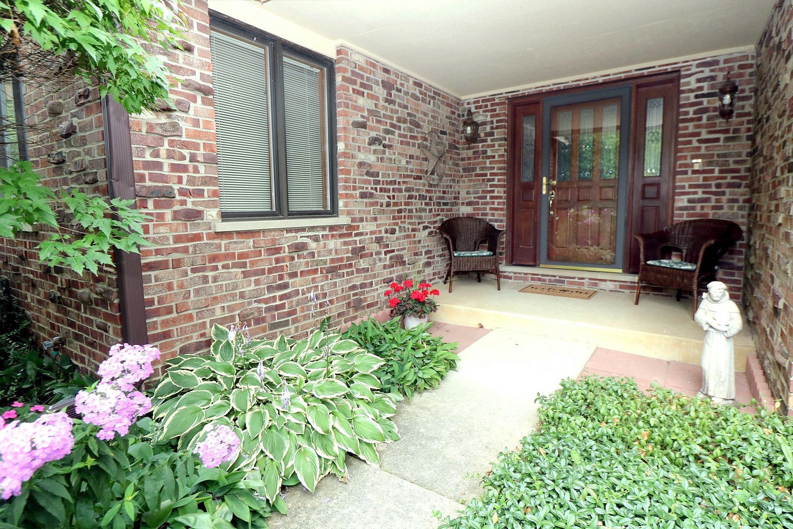 12N290 Jackson Drive Elgin, IL 60124 - Photo 2 of 6 a front view of a house with a porch