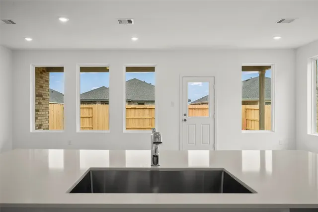a view of a kitchen with a sink dishwasher and a large window