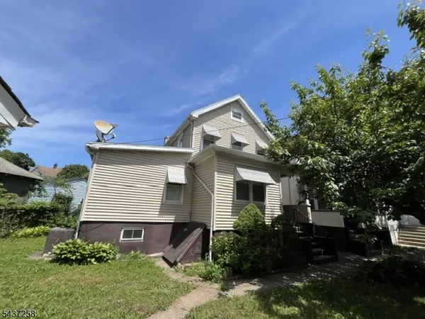 a front view of house with a garden