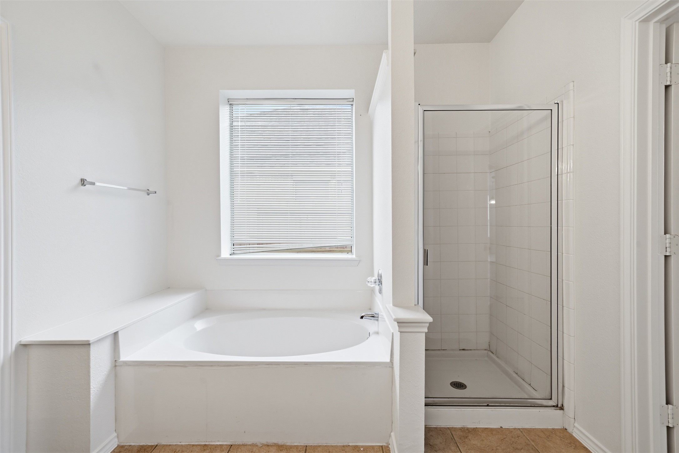 118 Invierno Street Kyle, TX 78640 - Photo 28 of 37 Unwind in the large soaking tub or refresh in the adjacent shower, a sanctuary for daily rejuvenation.