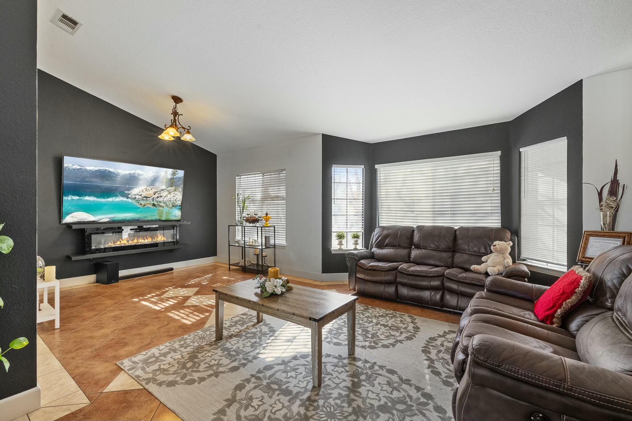 36070 43rd Street East Palmdale, CA 93552 - Photo 12 of 53 a living room with furniture and a flat screen tv