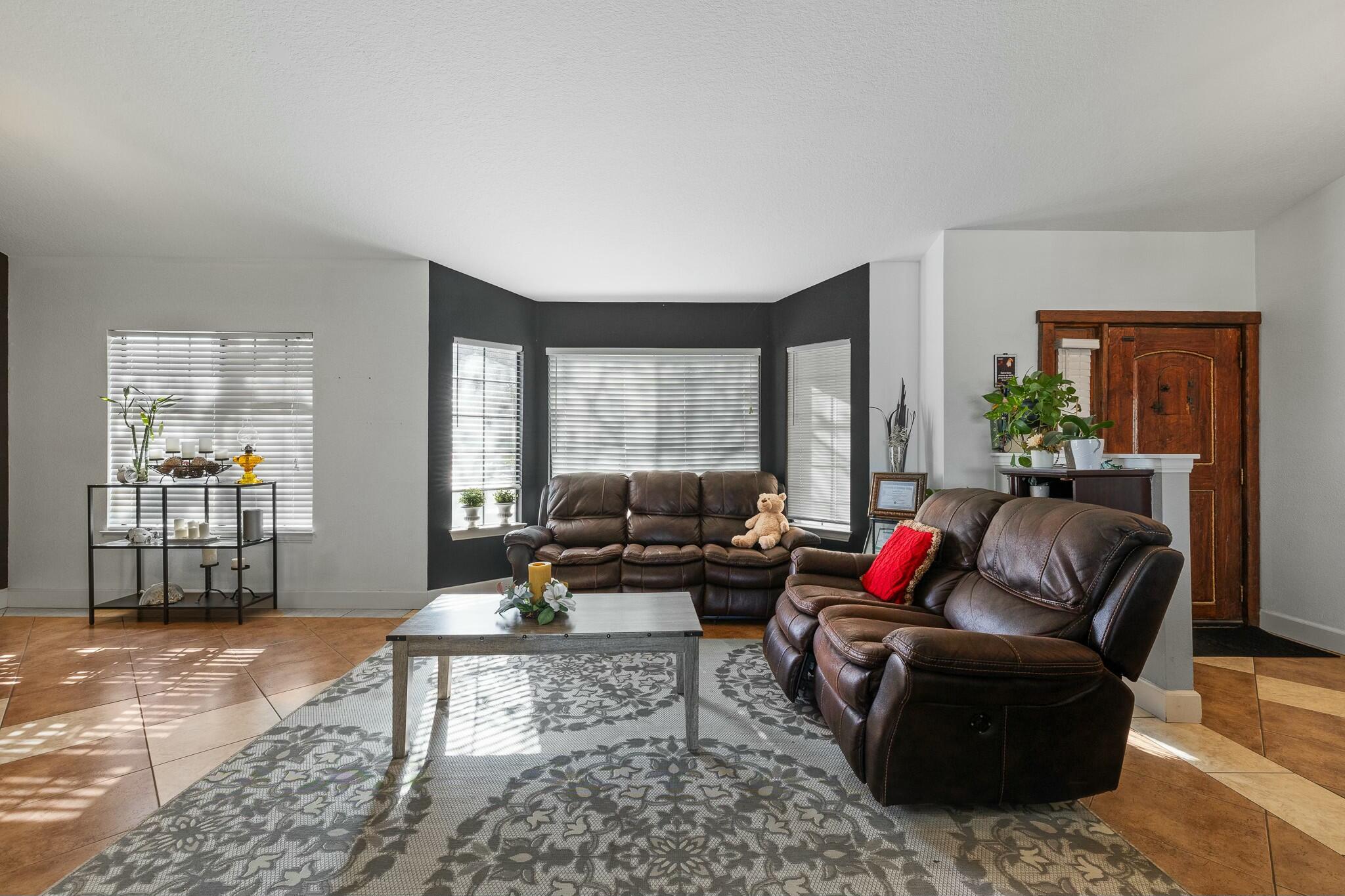 36070 43rd Street East Palmdale, CA 93552 - Photo 15 of 53 a living room with furniture and a large window