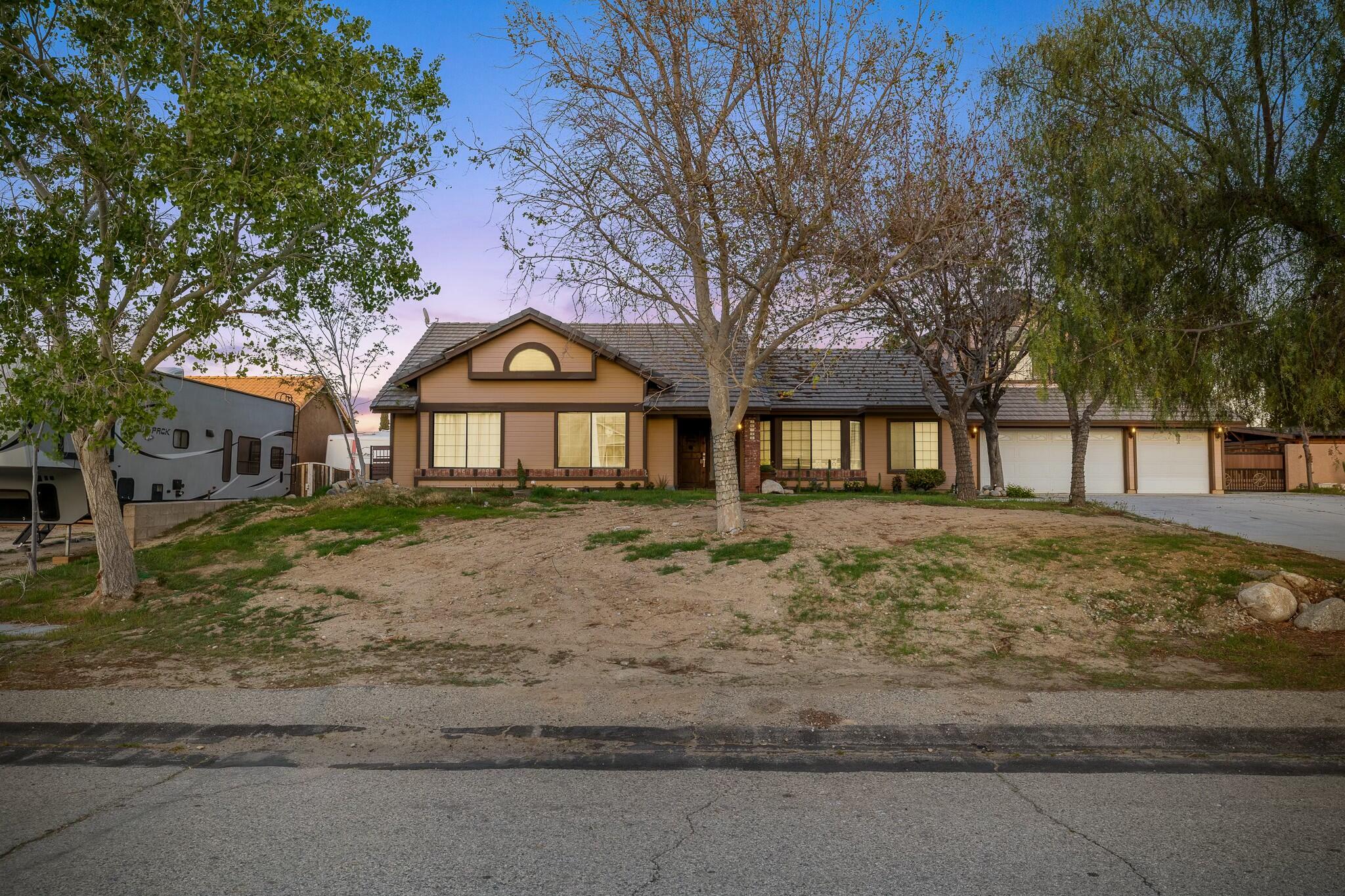 36070 43rd Street East Palmdale, CA 93552 - Photo 2 of 53 a front view of a house with a yard