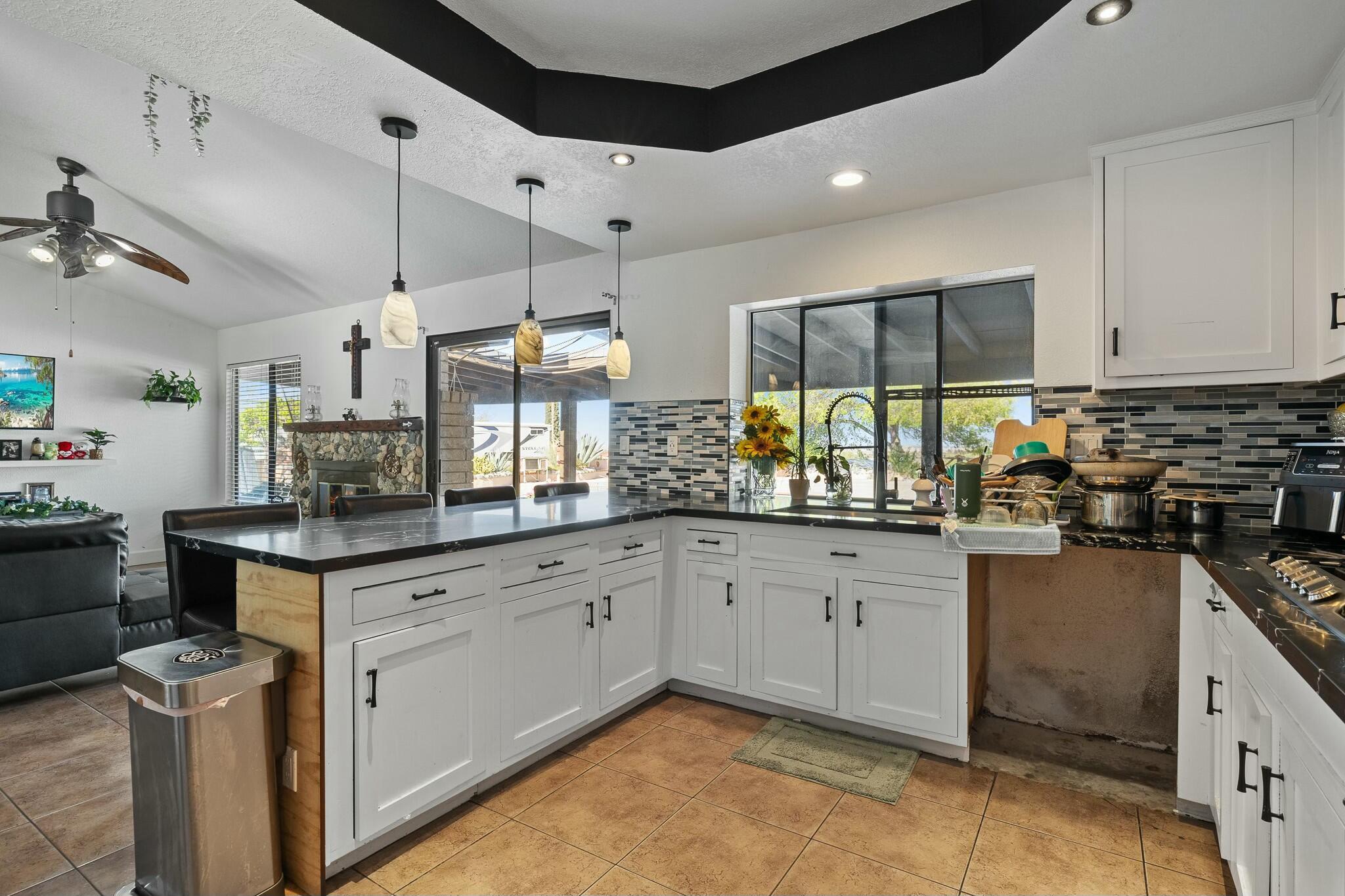 36070 43rd Street East Palmdale, CA 93552 - Photo 25 of 53 a kitchen with granite countertop a sink stove and cabinets