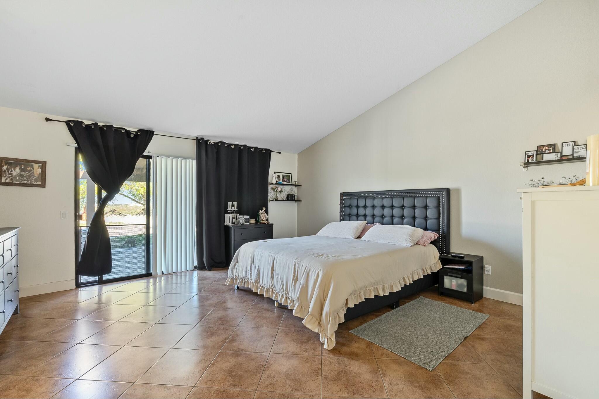36070 43rd Street East Palmdale, CA 93552 - Photo 29 of 53 a spacious bedroom with a bed and a refrigerator