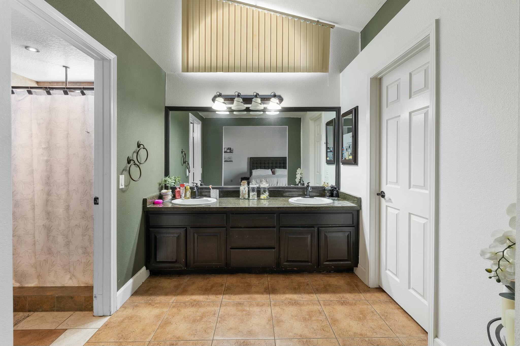 36070 43rd Street East Palmdale, CA 93552 - Photo 32 of 53 a bathroom with a double vanity sink and a mirror