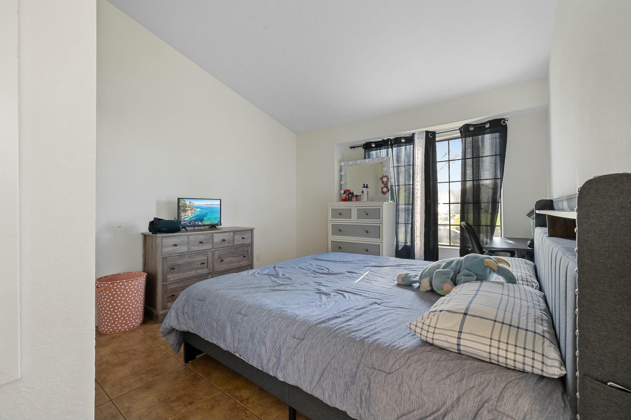 36070 43rd Street East Palmdale, CA 93552 - Photo 35 of 53 a bedroom with a bed and wooden floor