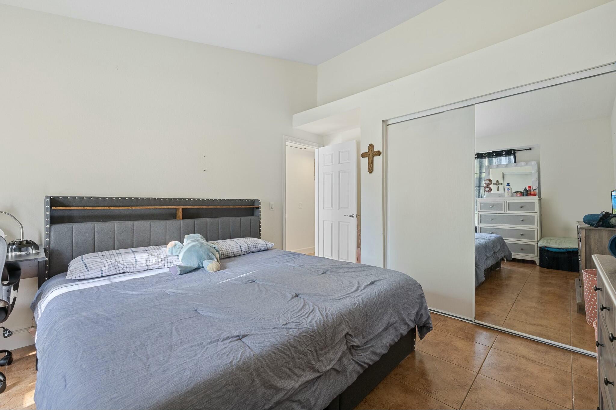 36070 43rd Street East Palmdale, CA 93552 - Photo 36 of 53 a bedroom with a bed and a table