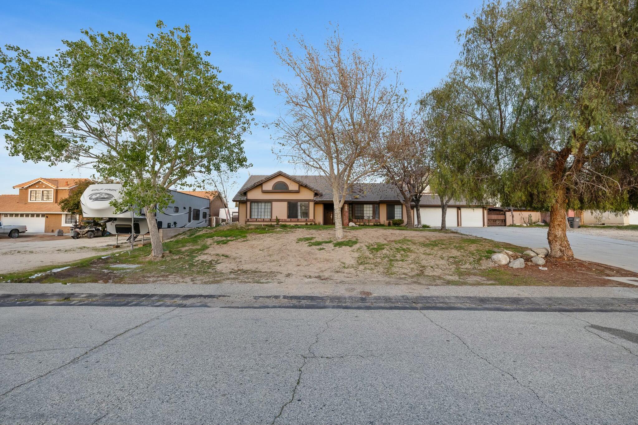 36070 43rd Street East Palmdale, CA 93552 - Photo 4 of 53 a view of street with large trees