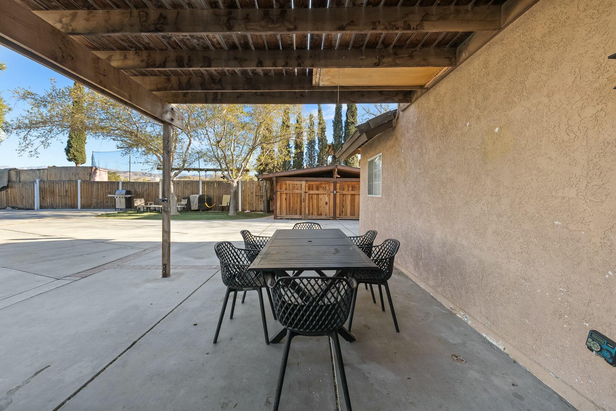 36070 43rd Street East Palmdale, CA 93552 - Photo 41 of 53 a view of a patio with a table and chairs