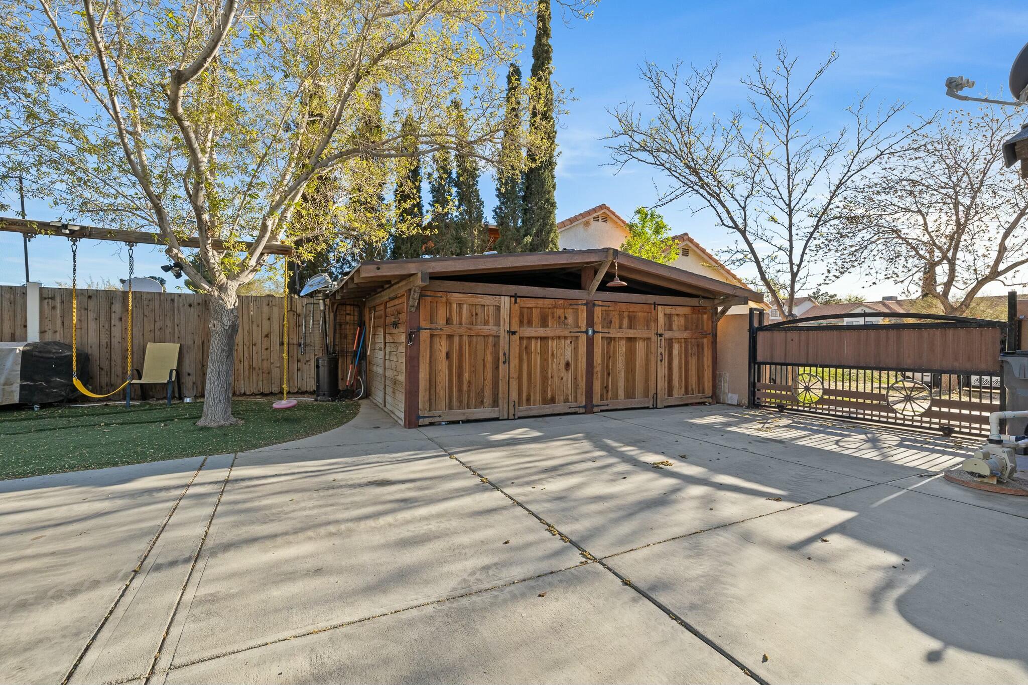 36070 43rd Street East Palmdale, CA 93552 - Photo 42 of 53 a front view of a house with a yard and garage