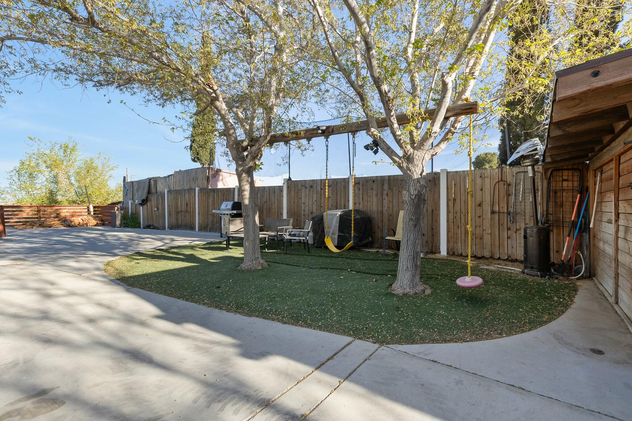 36070 43rd Street East Palmdale, CA 93552 - Photo 43 of 53 a front view of a house with garden