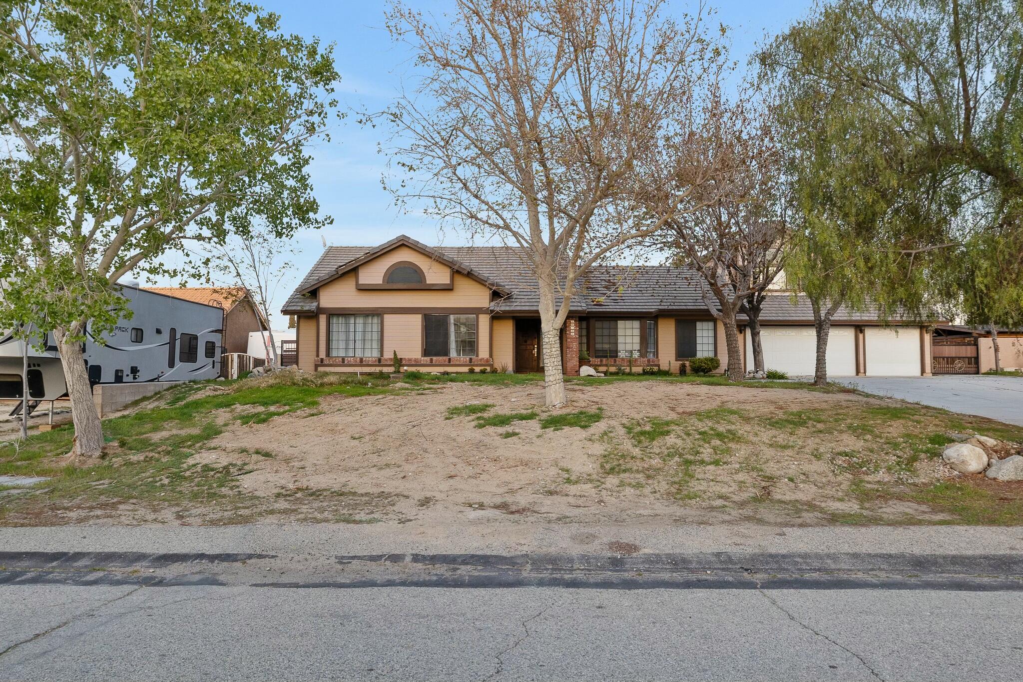 36070 43rd Street East Palmdale, CA 93552 - Photo 5 of 53 a front view of a house with a yard