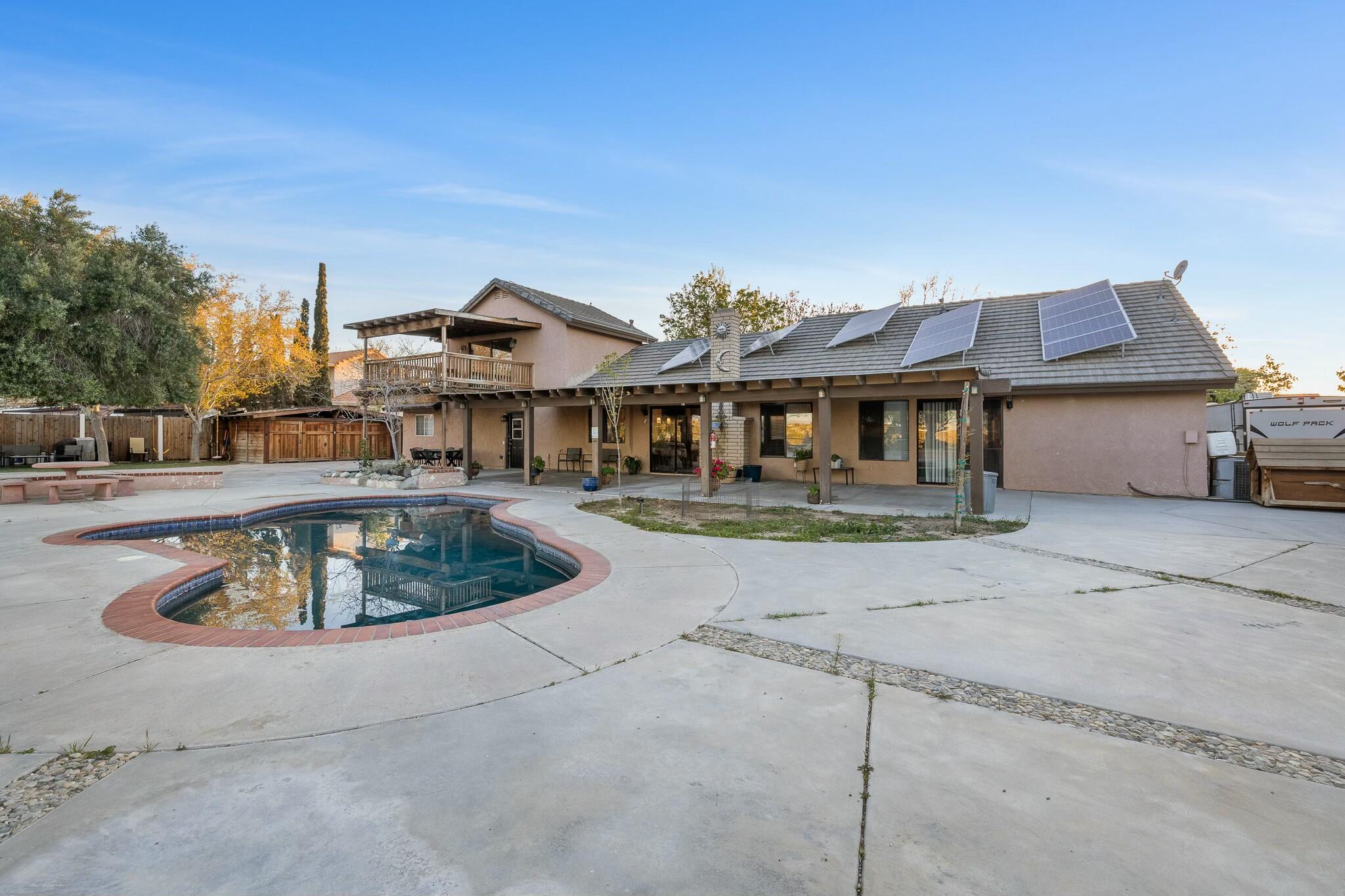 36070 43rd Street East Palmdale, CA 93552 - Photo 7 of 53 a front view of a house with a garden