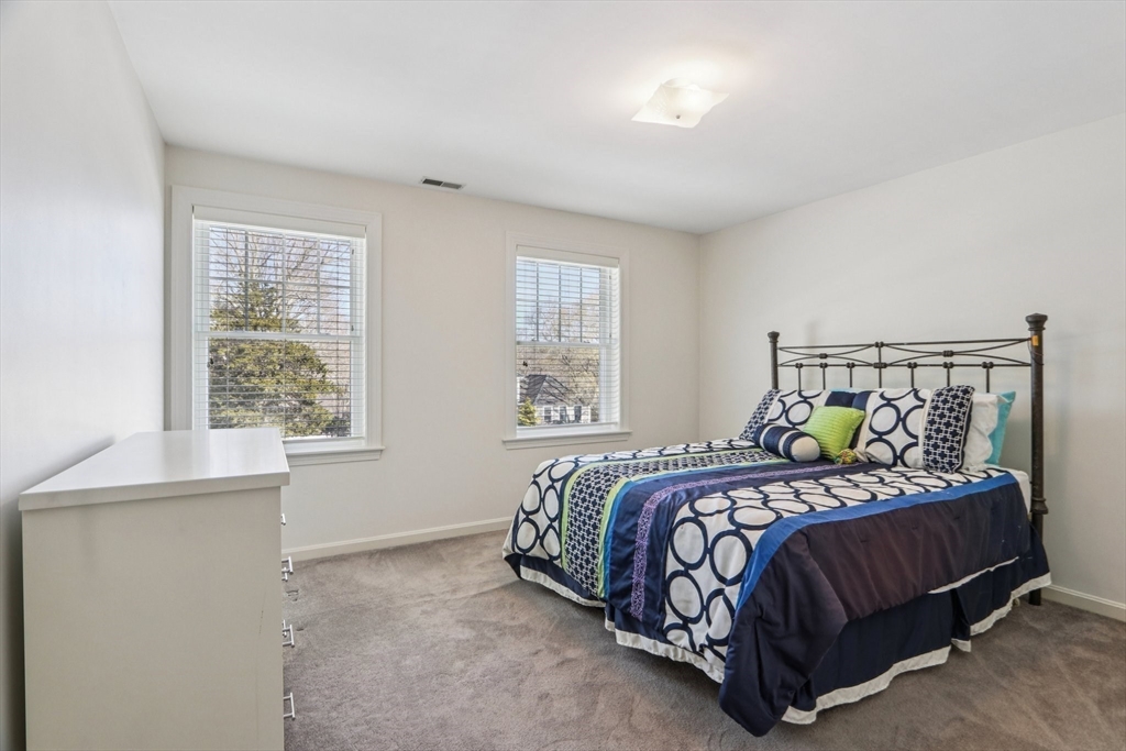 11 Thaxton Road Beverly, MA 01915 - Photo 22 of 40 a bedroom with a bed and window