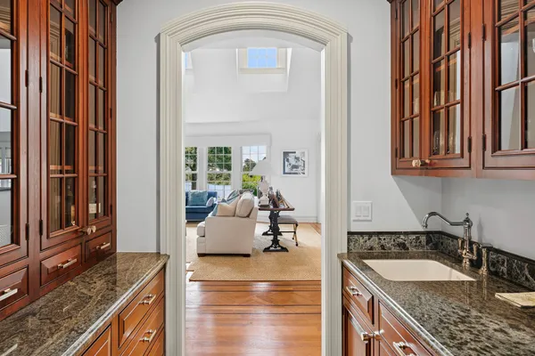 a view of a kitchen with kitchen island granite countertop living room