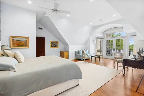 a bedroom with a large bed and a large window