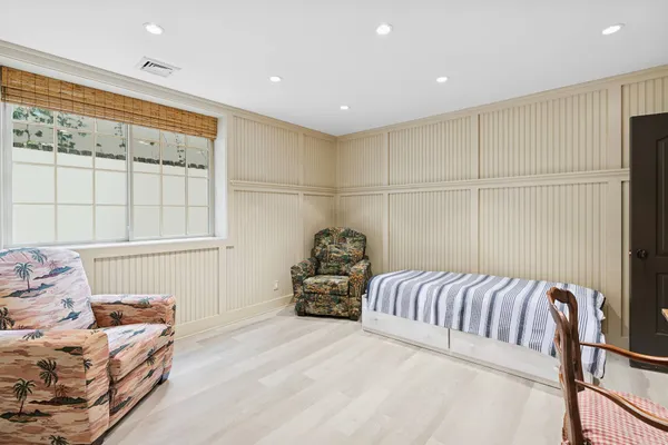 a bedroom with furniture and a chandelier