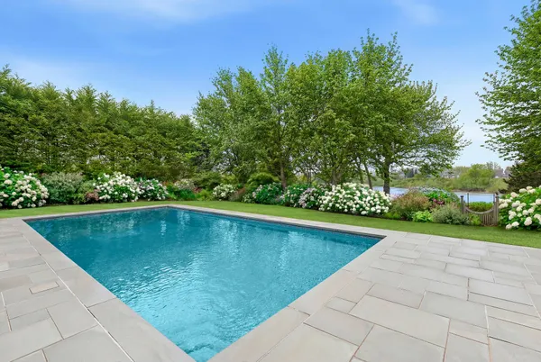 a view of a swimming pool with a yard