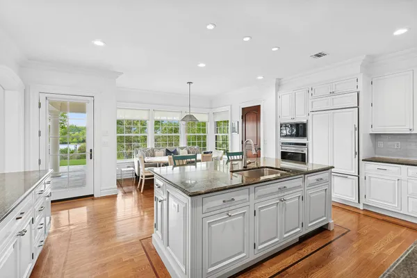 a kitchen with sink stove and refrigerator