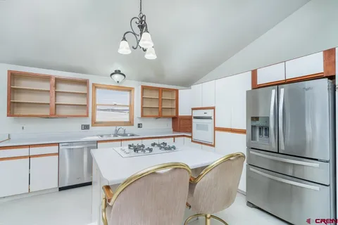 a view of an empty room with glass door and windows