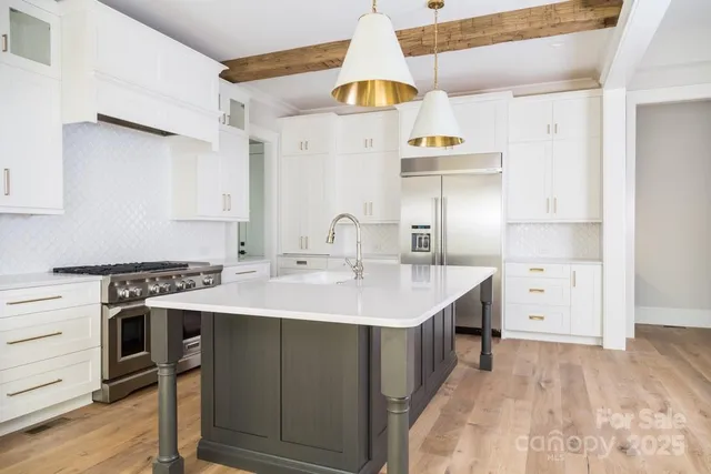 a kitchen with a sink a stove a refrigerator and a window