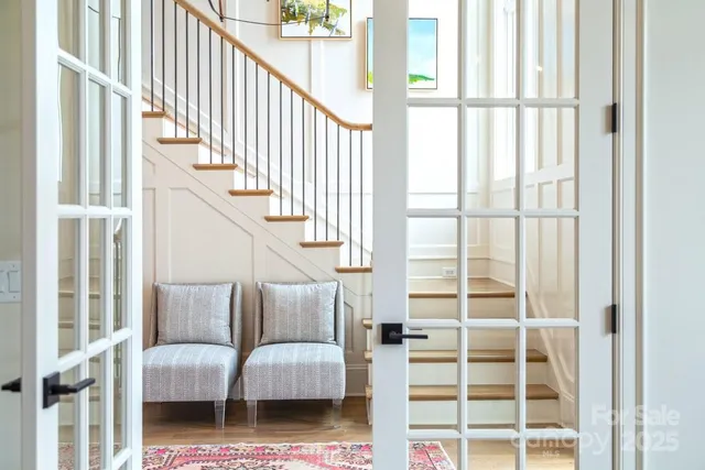 a living room with furniture and stairs