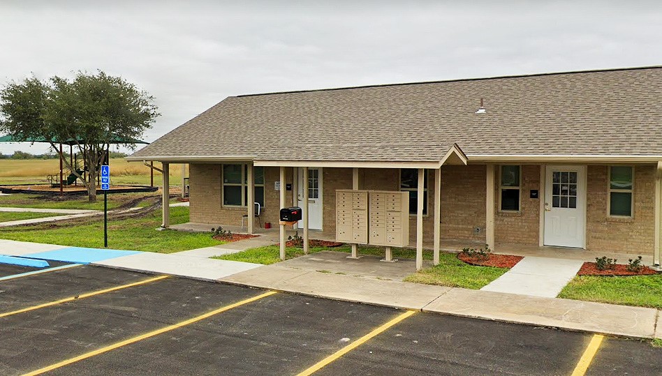 500 West Freeman Street Mathis, TX 78368 - Photo 7 of 9 a front view of a house with a yard and porch