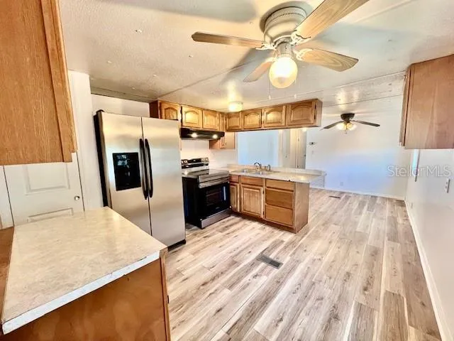 a kitchen with stainless steel appliances granite countertop a stove and a refrigerator